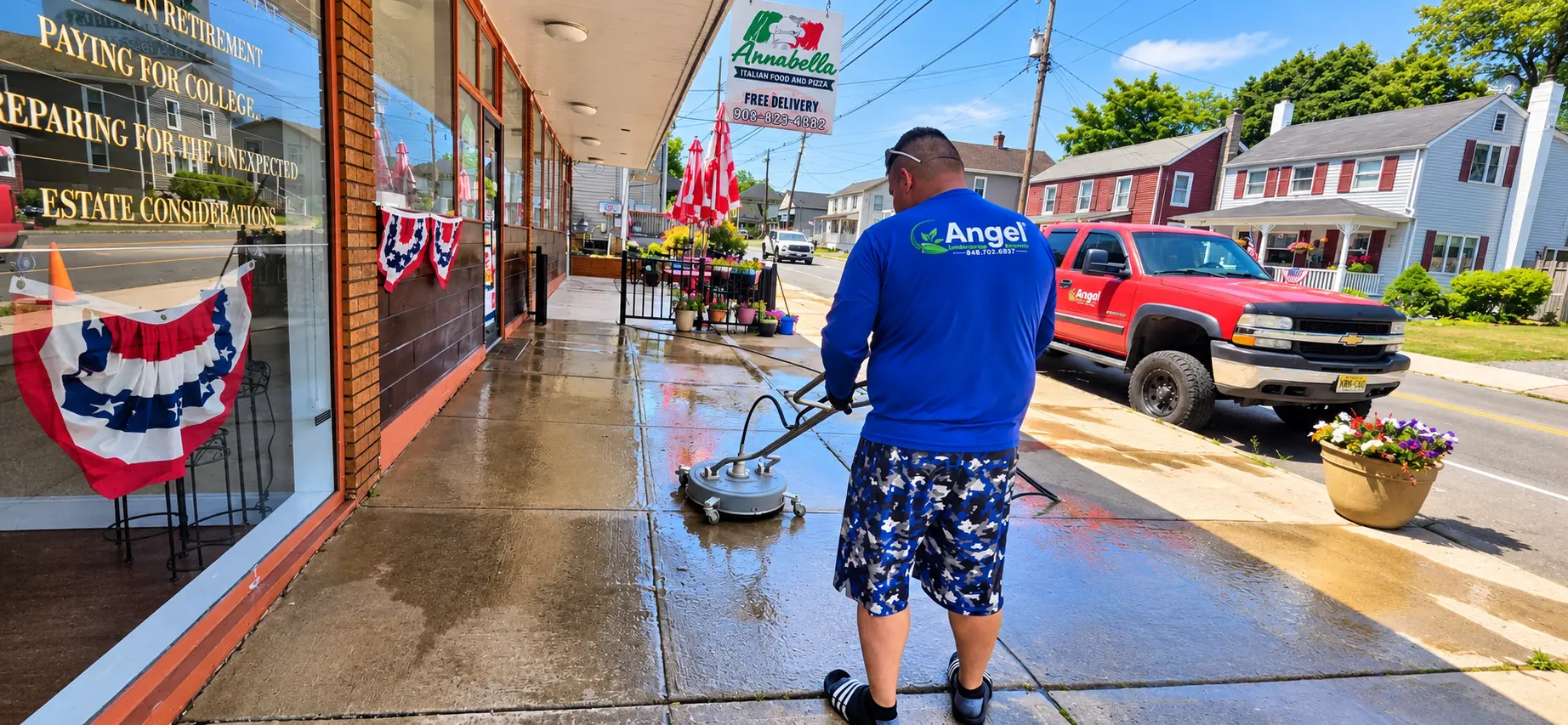 Rinsing a downtown sidewalk clean with a pressure washer surface cleaner